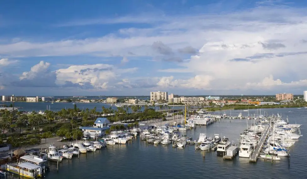 A bird's-eye view of Clearwater Beach Marina, showcasing the intricate layout of docks, boats, and surrounding waters in vivid detail.