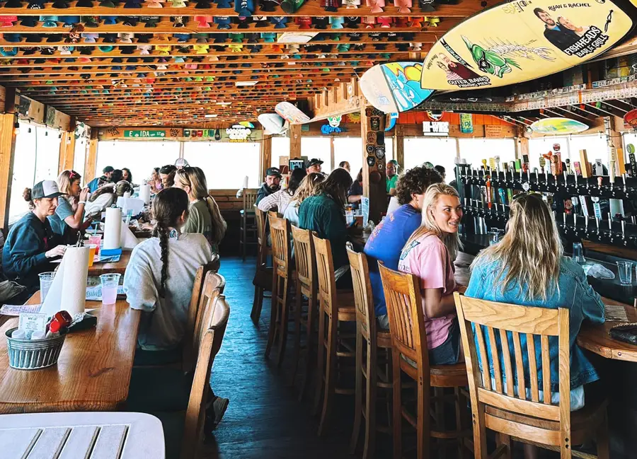 Pack patio of people enjoying themselves at Fish Heads Bar & Grill